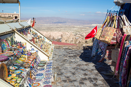 Ancient town and a castle of Uchisar dug from a mountains after sunrise, Cappadocia, Turkey.