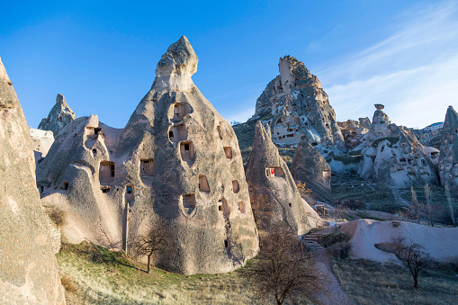 Ancient town and a castle of Uchisar dug from a mountains after sunrise, Cappadocia, Turkey.