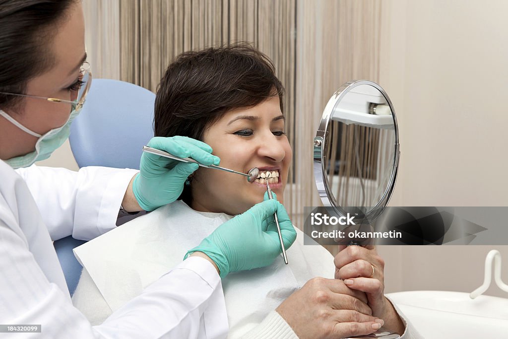 Dentist surgical intervention in dental office for teeth Dentist Stock Photo