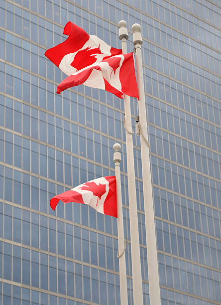 istock Canadian flags against corporate building background 184320168