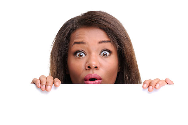 istock Businesswoman hiding behind a white empty banner 184320256