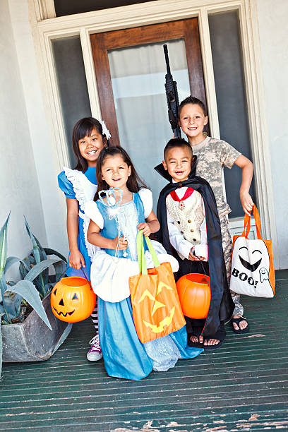 istock Young kids standing infront of a door trick or treating 184320308