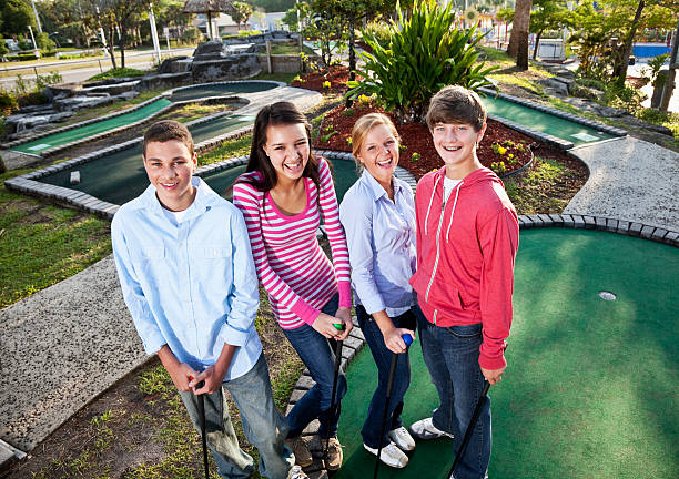 istock Teenagers playing miniature golf 184320403