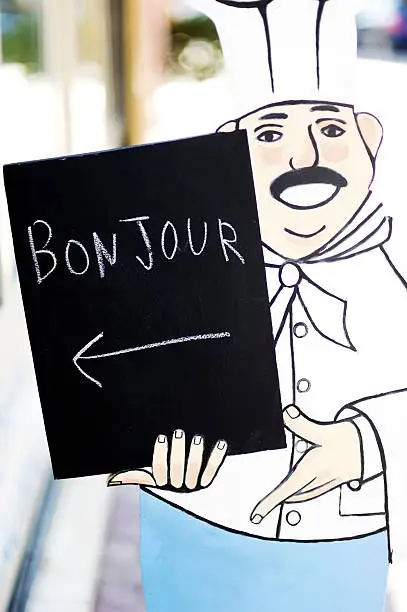French chef figure with Bonjour sign outside food shop in ProvenceMore like this