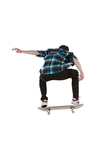 istock Rear view of a man performing stunt on skateboard 184320559