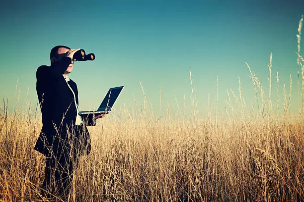 Photo of Businessman looking field for investment.