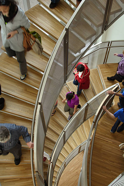 istock People Decending A Spiral Staircase 184321278