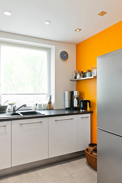 istock Modern kitchen interior with window and orange wall 184321284
