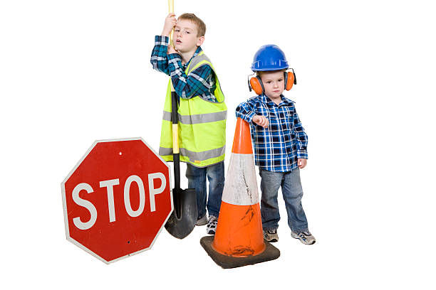 Cute Council Workers "Two little boys, council workers bored with their work, leaning on the shovel. Isolated on white." lazy construction laborer stock pictures, royalty-free photos & images