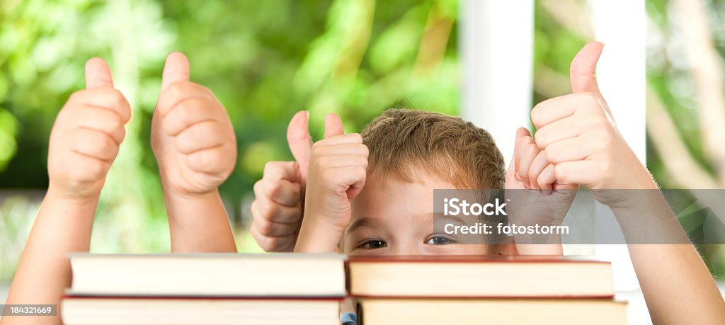Niños detrás de Pila de libros con mucha suerte - Foto de stock de Niño libre de derechos