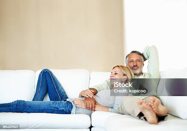 Mature Couple Resting On Sofa Stock Photo - Download Image Now - Mature Couple, Relaxation, Sofa