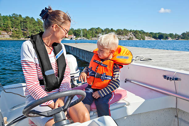 Boy with life jacket standing on deck of a boat, Florida Keys, USA