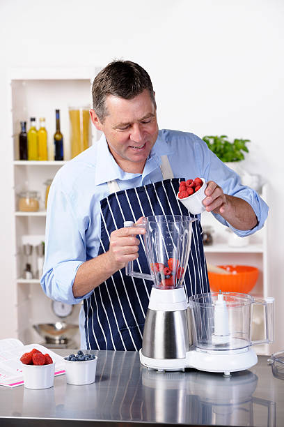 istock Mature Man Preparing A Healthy Drink/ Dessert 184322899
