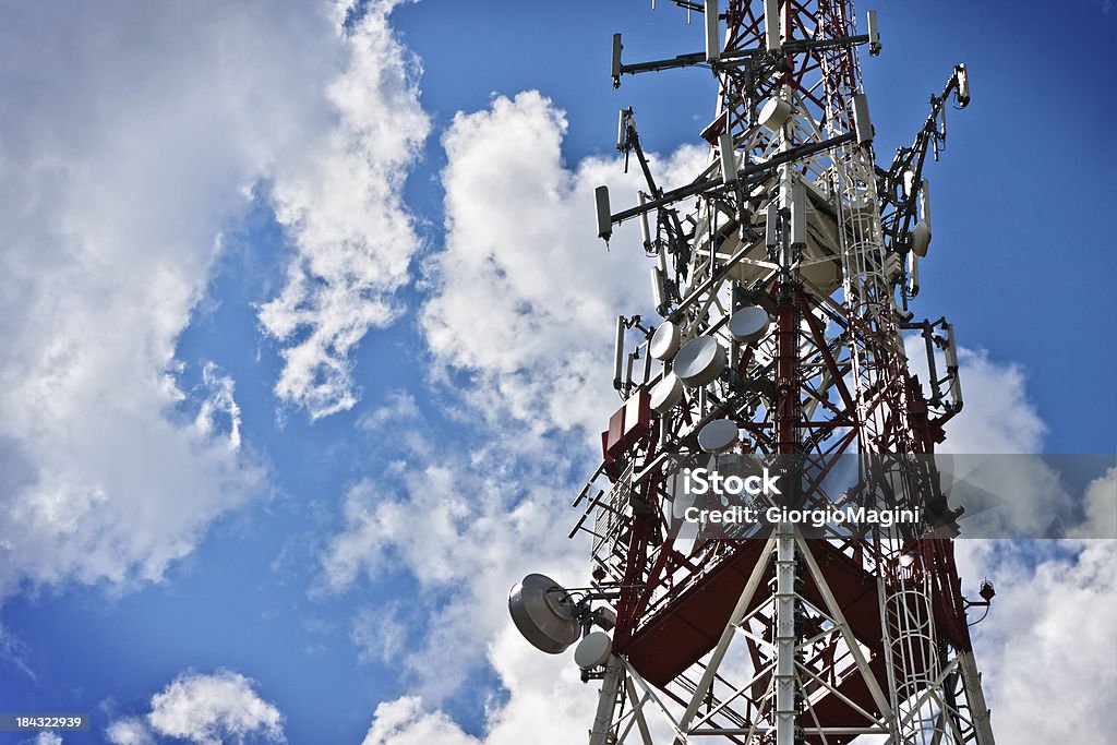 Communications Tower against Blue Cloudy Sky Communications tower against blue cloudy sky. Antenna - Aerial Stock Photo