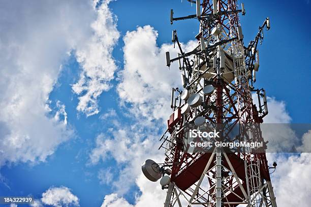 Communications Tower Against Blue Cloudy Sky Stock Photo - Download Image Now - Antenna - Aerial, Blue, Broadcasting