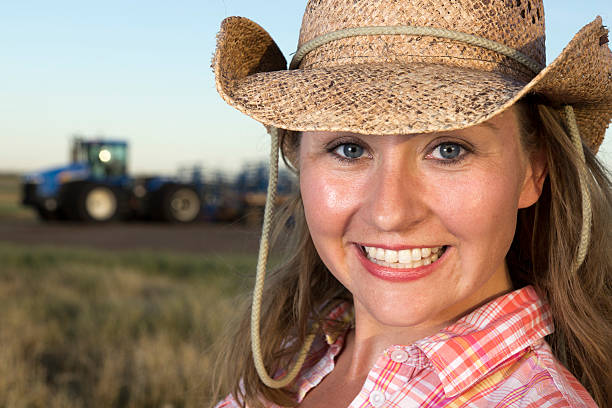 istock Cowgirl and Tractor 184323628
