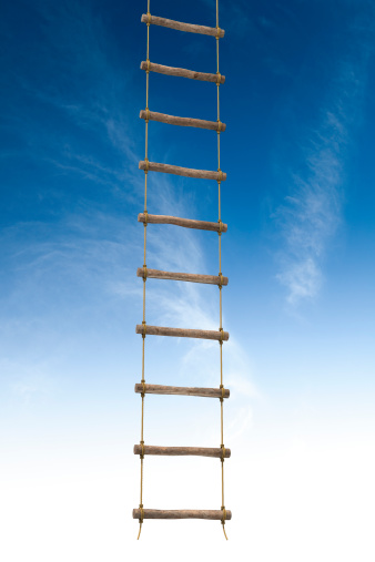 Rope ladder with blue sky.Escape the scene with this suspended rope ladder.This is a detailed 3d rendering.