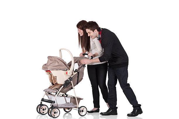 istock Couple smiling at their baby in a pram 184323820