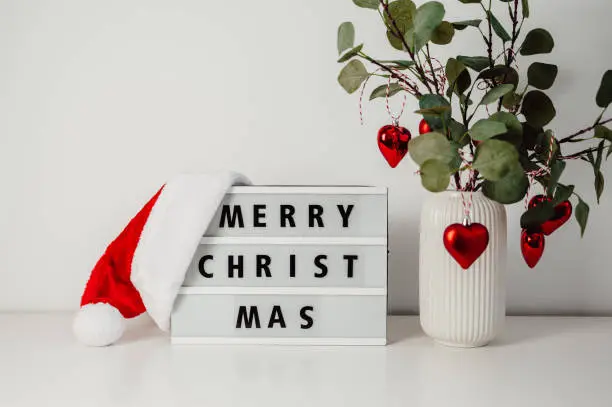 Decoration and celebration concept - merry christmas greeting on light box.minimalistic background