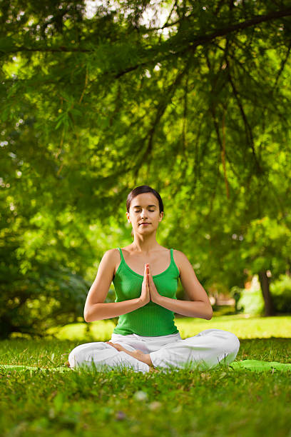 istock Young woman doing yoga exercise outdoor 184323857