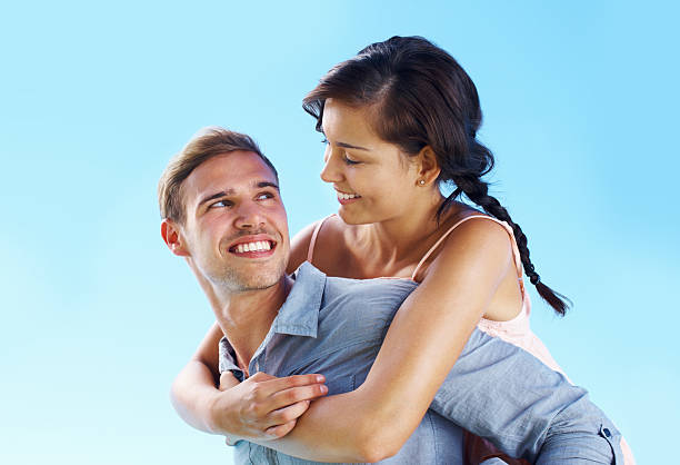 istock Loving man carrying woman on back 184323959