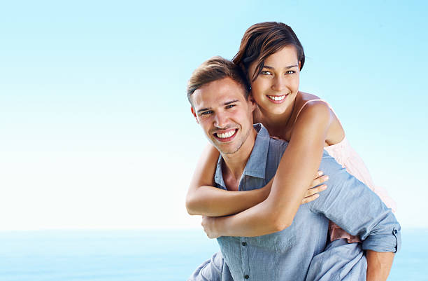 istock Man giving woman a piggyback ride 184323961