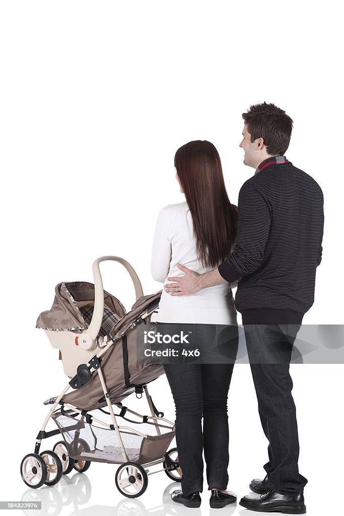 Couple standing near a pram Couple standing near a pramhttp://www.twodozendesign.info/i/1.png Cut Out Stock Photo