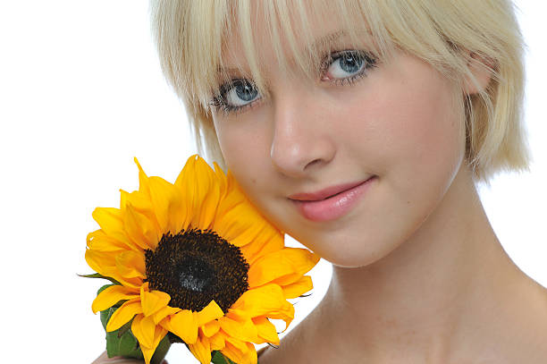 Headshot of beautiful young girl Headshot of beautiful young girl holding sunflower. late teens isolated on white one person cute stock pictures, royalty-free photos & images