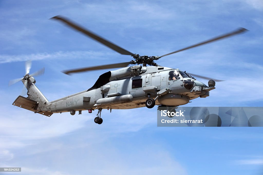 Looking up at a Seahawk helicopter flying in blue sky U.S. Navy SH-60 Seahawk helicopter.  Helicopter Stock Photo