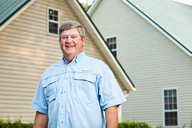 istock Senior man standing outside home 184324287
