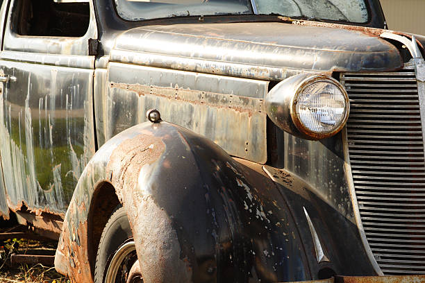 istock Black 1940's car, rusted and abandoned in the sunshine 184324969