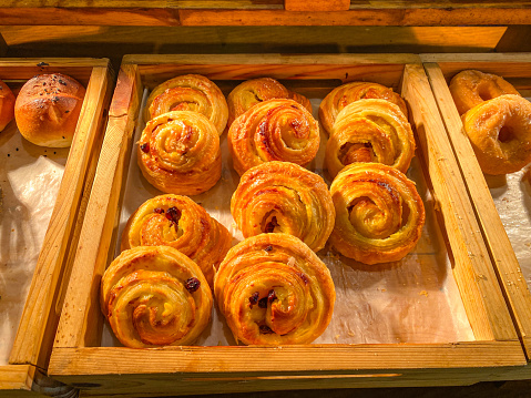 raisin danish on a wooden container in a hotel restaurant as a breakfast menu
