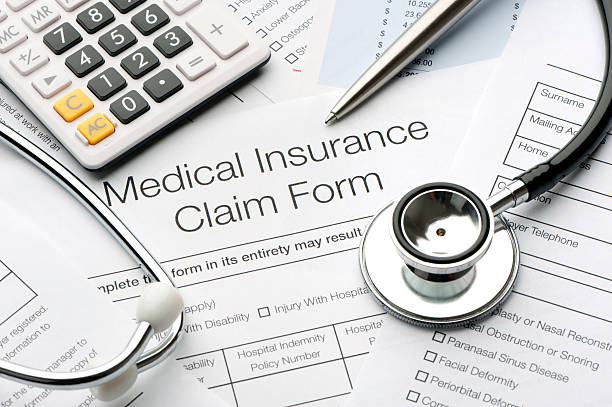 Close up of a medical insurance form Close up of a medical insurance form with stethoscope claim form stock pictures, royalty-free photos & images