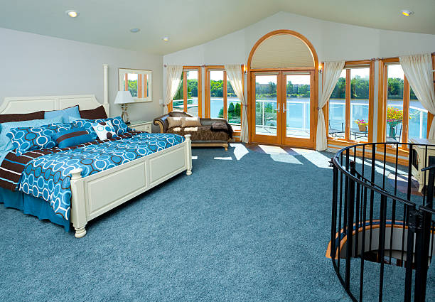 Spacious Master Bedroom With Spiral Staircase, Waterfront View "Spacious Master Bedroom With Spiral Staircase, Waterfront View" shag rug stock pictures, royalty-free photos & images