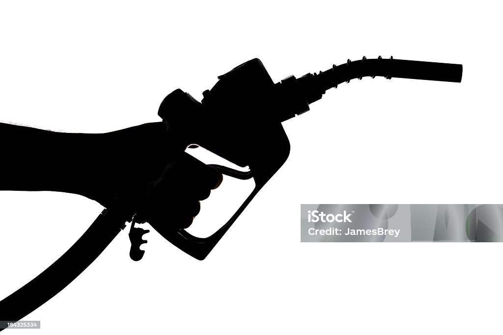 Silhouetted Рука держит бензин насос форсунки - Стоковые фото Белый роялти-фри