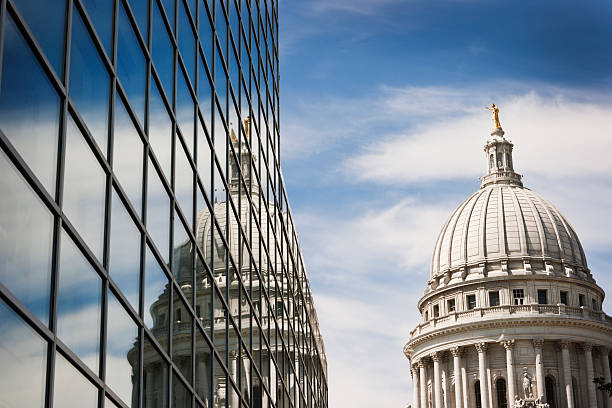 Wisconsin State Capitol Dome Reflecting in Steel and Glass Building Horizontal view of the Wisconsin State Capitol Dome reflecting into the windows of a steel and glass office building on a sunny day. neo classical photos stock pictures, royalty-free photos & images