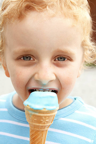 istock Little boy licking ice cream 184325637