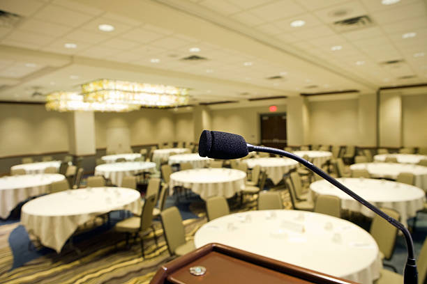 Microphone at Podium in Hotel Convention Room "A microphone, at a podium in an empty hotel convention room, ready for a presentation." ballroom stock pictures, royalty-free photos & images