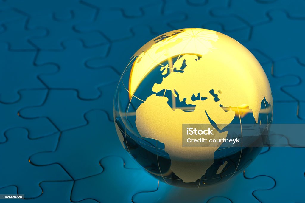 Glowing globe on a blue jigsaw puzzle Glowing globe on a blue jigsaw puzzle showing Europe Africa Stock Photo