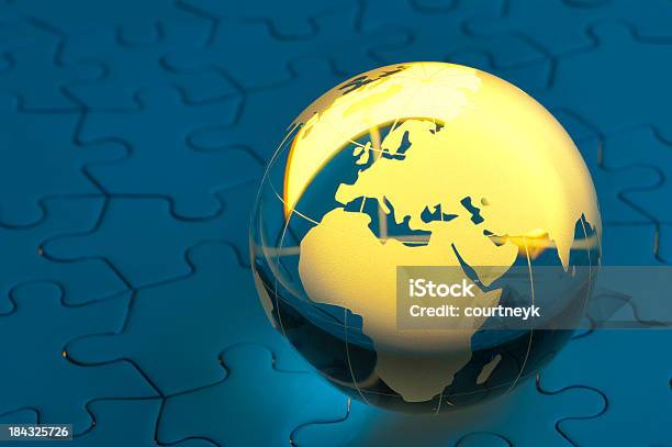 Glowing Globe On A Blue Jigsaw Puzzle Stock Photo - Download Image Now - Africa, Blue, Business