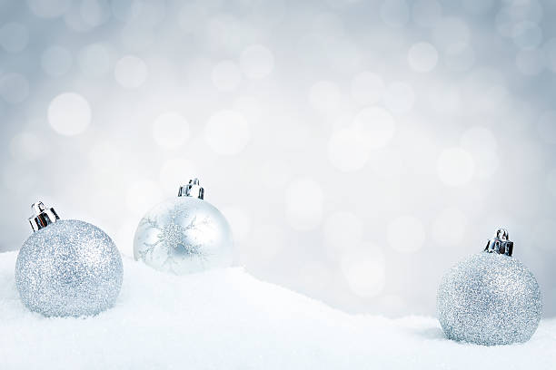 istock Silver Christmas baubles on snow with a silver background 184325861