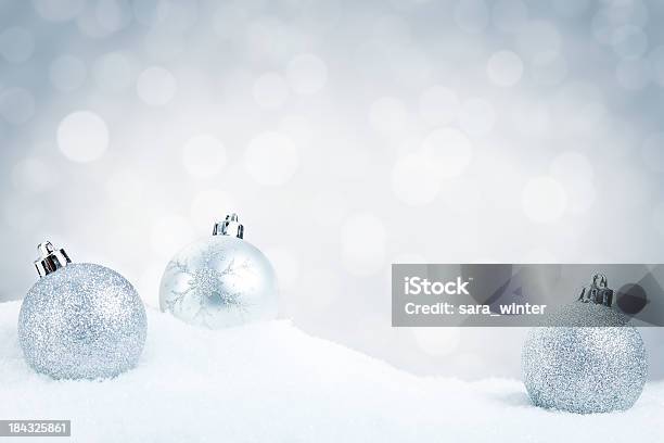 Silver Christmas Baubles On Snow With A Silver Background Stock Photo - Download Image Now