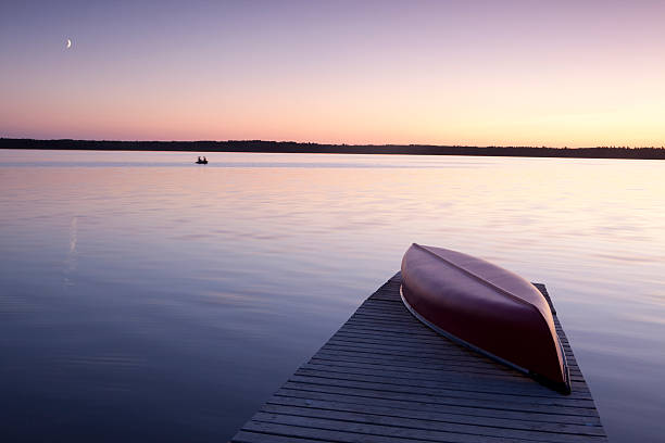 Red Canoe "Red Canoe, sunset at Lake Audy,Manitoba.  Riding Mountain National Park of Canada." riding mountain national park stock pictures, royalty-free photos & images