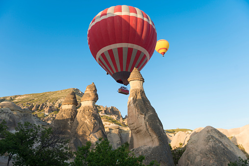 Many hot air balloons take flight at sunrise.