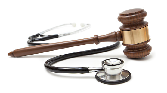 Gavel and stethoscope on white background. Medical law concept.
