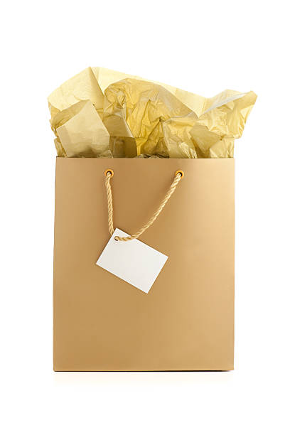 Gold gift bag with tissue and blank giftcard stock photo