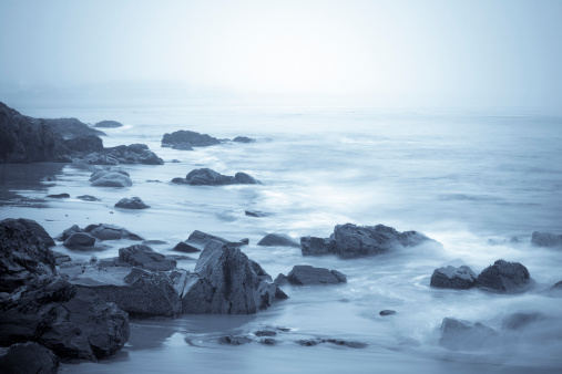 A foggy night on a rocky coast line in Maine. Water is blurred due to long exposure.See related: