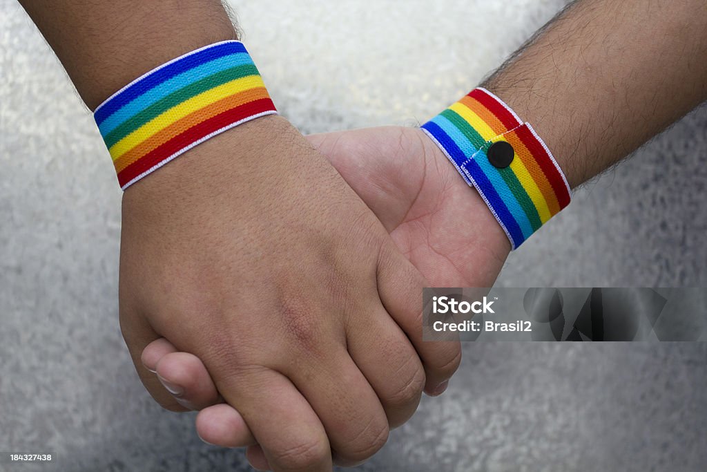 Gay dating Two hands together celebrating the Gay Pride Forbidden Stock Photo
