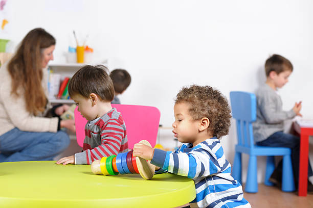 istock Portrait Showing Children Engaged In Different Activities At Nursery 184327615