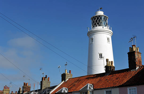 Southwold Lighthouse "Lighthouse rises above the roofs and chimney pots of Southwold in Suffolk, UKSouthwold Lighthouse is a lighthouse in Southwold, Suffolk, England. It was constructed by Trinity House from 1887 and was taken into service in 1890." southwold stock pictures, royalty-free photos & images